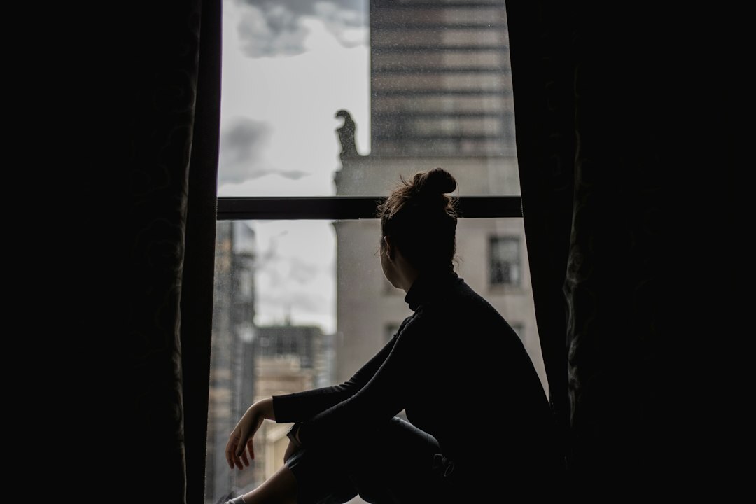 mystery author sitting by window
